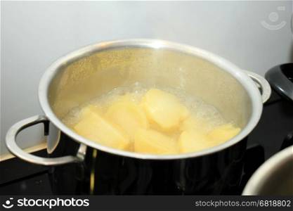 Boiling potatoes in a pan in hot water