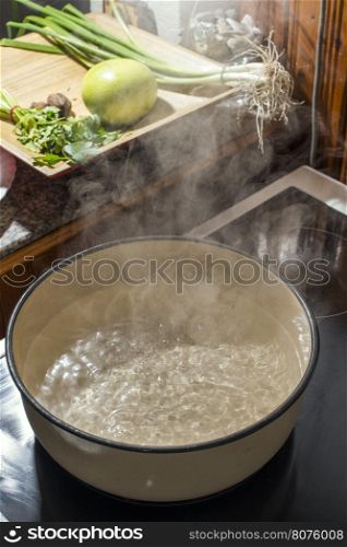 Boiling water in a saucepan. Vintage kitchen
