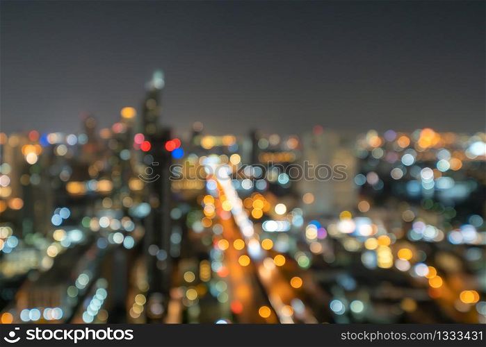 Bokeh abstract background of skyscraper buildings in Bangkok city, Thailand with lights, Blurry photo at night time. Cityscape