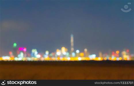 Bokeh background of skyscraper buildings in Dubai city skyline, UAE with lights, Blurry photo at night time. Cityscape