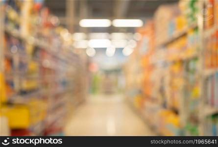 Bokeh blurry background of aisle of label products on shelves at supermarket or grocery store. Food shopping. Lifestyle. Abstract