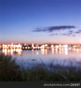 Bokeh of city light with lake view, blurred background in nature