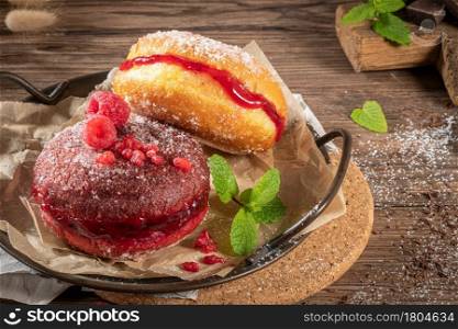 "Bolas de Berlim, or "Berlin Balls". Portuguese fried dough with sugar, Filled with chocolate or raspberry jam. Portuguese fried dough with sugar. Chocolate and beetroot berliner Pancakes"