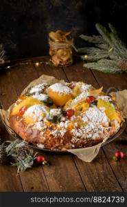 Bolo do Rei or King’s Cake, Made for Christmas, Carnavale or Mardi Gras with Christmas season elements in Background.