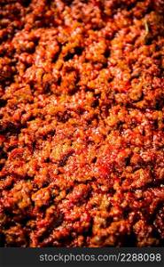 Bolognese sauce. Macro background. The texture of the Bolognese sauce. High quality photo. Bolognese sauce. Macro background. The texture of the Bolognese sauce.