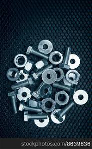 Bolts and nuts on steel surface. Mechanic items for maintenance. Hardware parts to build and repair. Technical tools background