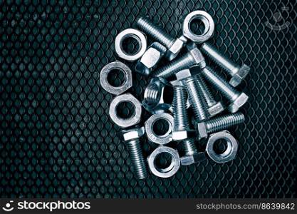 Bolts and nuts on steel surface. Mechanic items for maintenance. Hardware parts to build and repair. Technical tools background