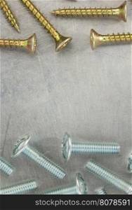 bolts and screws at metal background texture