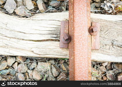 Bolts rusted wood. Particular of a rail tie with track