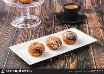 Bombolone or bomboloni is an Italian filled donut and snack food. German donuts - krapfen or berliner - filled with jam and chocolate
