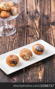 Bombolone or bomboloni is an Italian filled donut and snack food. German donuts - krapfen or berliner - filled with jam and chocolate