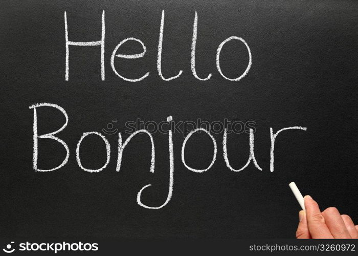 Bonjour, hello in French written on a blackboard.