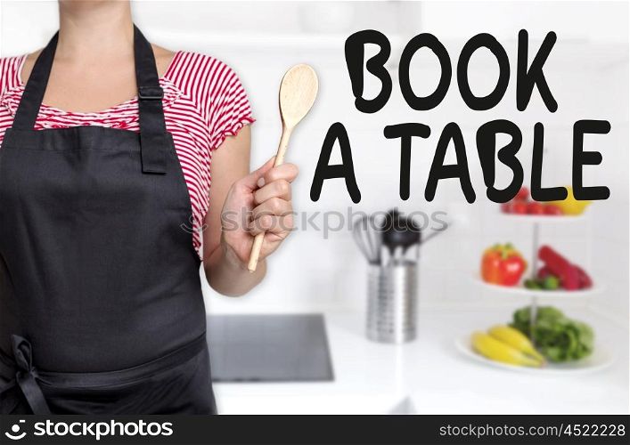 book a table cook holding wooden spoon concept. book a table cook holding wooden spoon concept.