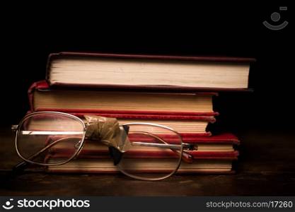 Book and glasses on wooden surface