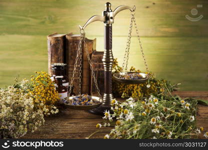 Book and Herbal medicine on wooden table background. Herbal medicine and book on wooden table background