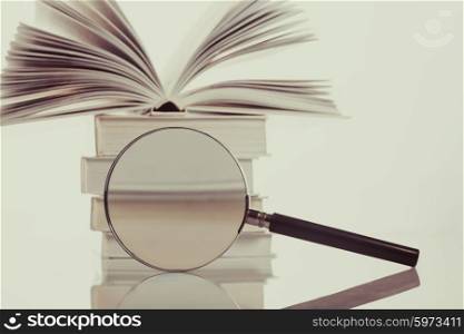 Book and magnifying glass isolated on white. Search concept. Search concept vintage