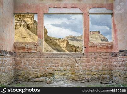 Book Cliffs in eastern Utah as seen through windows of a ruined ghost town building