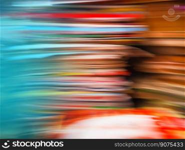 Book in library bookshelf blurred for background or backdrop. Abstract bokeh background with education learning concept.. Blur bright colorful books cabinet library. Bright colorful library blurred background.