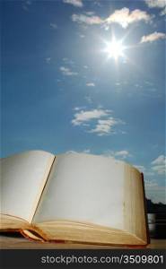 book of wisdom on sun sky background