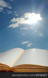 book of wisdom on sun sky background