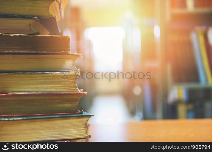 book stacked in library / education concept back to school and business study with old books on a wooden table