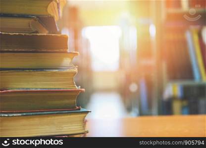 book stacked in library / education concept back to school and business study with old books on a wooden table