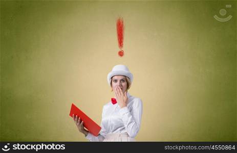 Book that blow up your imagination. Young woman in white hat with opened red book in hands
