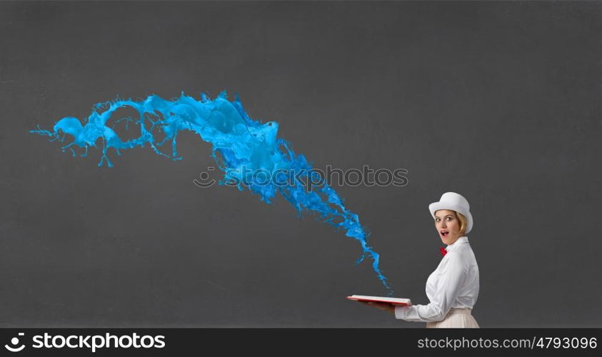 Book that blow up your imagination. Young woman in white hat with opened book in hands and splashes flying out