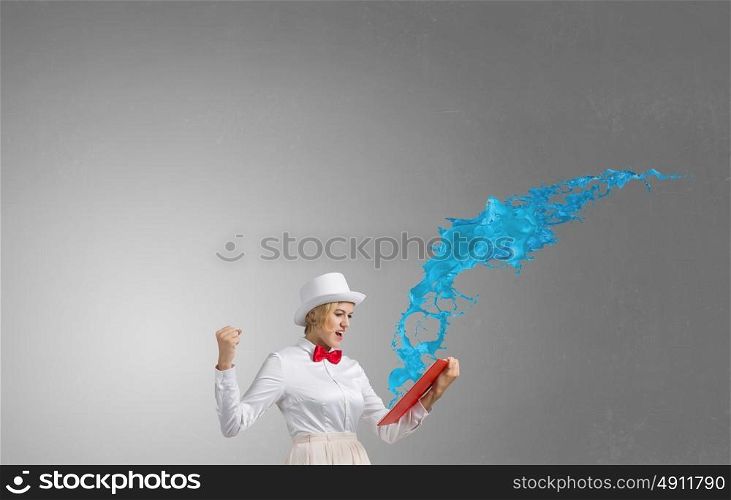 Book that blow up your imagination. Young woman in white hat with opened book in hands and splashes flying out