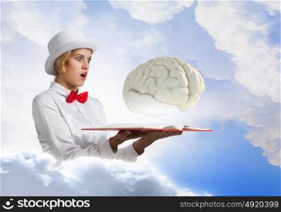Book that blow up your imagination. Young woman in white hat with opened red book in hands