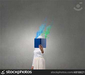 Book that blows up your mind. Woman with opened book against her face and colorful splashes coming from pages