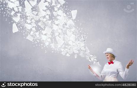 Book that blows up your mind. Young woman in white hat with opened red book in hands