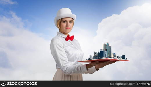 Book that develope your imagination. Young woman in white cylinder and red bowtie with book in hands