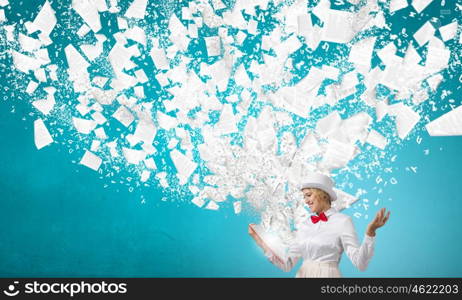 Book that develope your imagination. Young woman in white cylinder and red bowtie with book in hands