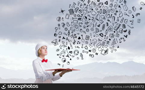 Book that develope your imagination. Young woman in white cylinder and red bowtie with book in hands