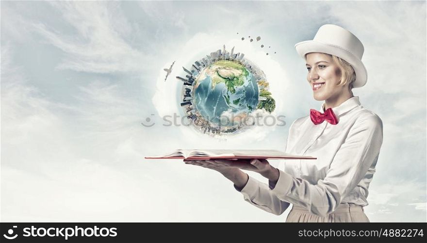 Book that develope your imagination. Young woman in white cylinder and red bowtie with book in hands. Elements of this image are furnished by NASA