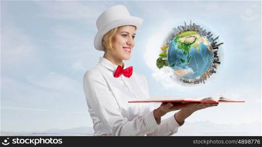 Book that develope your imagination. Young woman in white cylinder and red bowtie with book in hands. Elements of this image are furnished by NASA