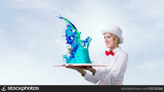 Book that develope your imagination. Young woman in white cylinder and red bowtie with book in hands