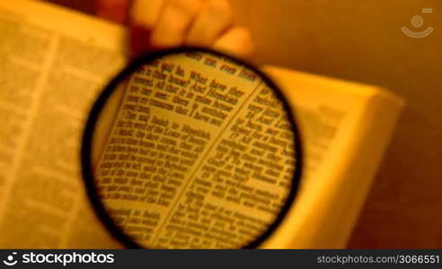 book through a magnifying glass