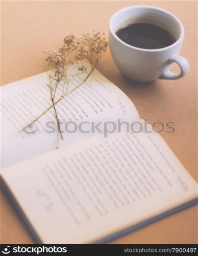 Book with black coffee , retro filter effect