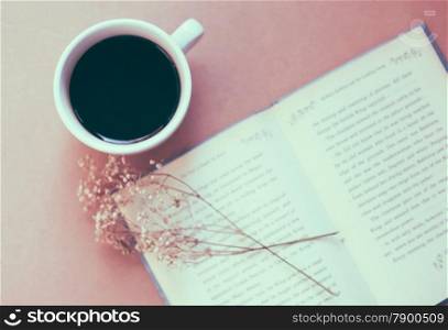 Book with black coffee , retro filter effect