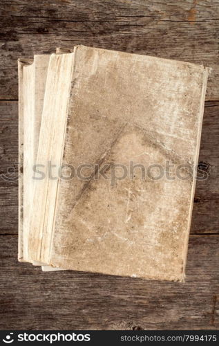 Book with old canvas cover on the wooden background