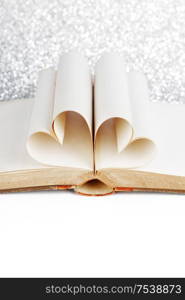 Book with opened pages and shape of heart love reading concept. Book with pages shape of heart