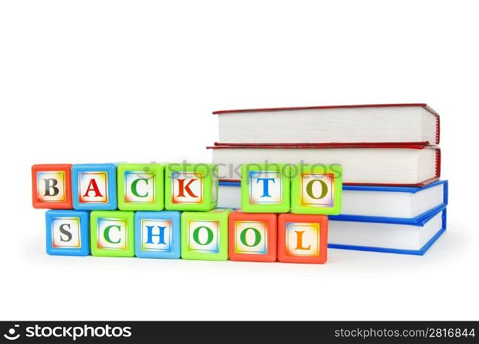 Books and alphabet blocks isolated on white