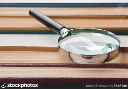 books and magnifying glass