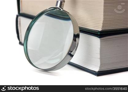 books and magnifying glass isolated on white background