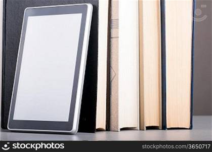 Books and modern tablet computer, concept of evolution