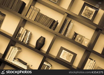 Books and picture frames in shelves