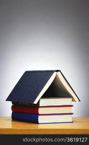 Books arranged in shape of house, studio shot