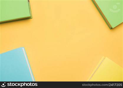 books colorful covers yellow background
